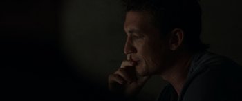 Movie still from “Spiderhead” (2022), directed by Joseph Kosinski – A person with his hand under his chin; Close Up shot, Low angle