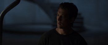 Movie still from “Spiderhead” (2022), directed by Joseph Kosinski – A person wearing a black t - shirt; Close Up shot, Over the shoulder angle