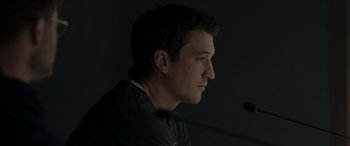 Movie still from “Spiderhead” (2022), directed by Joseph Kosinski – A person in a dark room; Close Up shot, Low angle