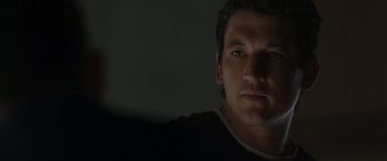 Movie still from “Spiderhead” (2022), directed by Joseph Kosinski – A person's face in the dark; Close Up shot, Low angle