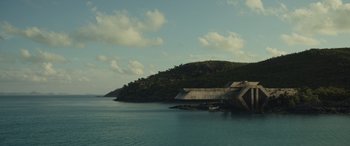 Movie still from “Spiderhead” (2022), directed by Joseph Kosinski – A large body of water with a bridge on it; Extreme Wide shot, Low angle