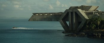 Movie still from “Spiderhead” (2022), directed by Joseph Kosinski – A concrete bridge over a body of water; Extreme Wide shot, Low angle