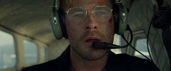 Movie still from “Spiderhead” (2022), directed by Joseph Kosinski – A person wearing headphones and glasses; Close Up shot, Low angle