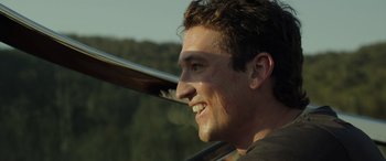 Movie still from “Spiderhead” (2022), directed by Joseph Kosinski – A person with a baseball bat; Close Up shot, Low angle