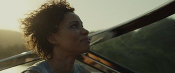 Movie still from “Spiderhead” (2022), directed by Joseph Kosinski – A person sitting in a car; Close Up shot, Low angle