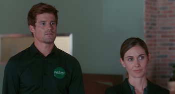 Movie still from “Spin Me Round” (2022), directed by Jeff Baena – A man and a woman standing next to each other; Medium shot, Over the shoulder angle