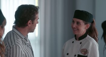 Movie still from “Spin Me Round” (2022), directed by Jeff Baena – A man and a woman wearing chef's uniforms; Close Up shot, Over the shoulder angle