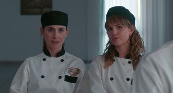 Movie still from “Spin Me Round” (2022), directed by Jeff Baena – A couple of women standing next to each other; Close Up shot, Over the shoulder angle