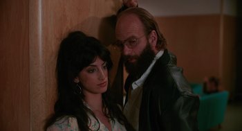 Movie still from “Spin Me Round” (2022), directed by Jeff Baena – A man and a woman posing for a picture; Close Up shot, Low angle