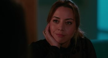 Movie still from “Spin Me Round” (2022), directed by Jeff Baena – A person with her hand on her face; Close Up shot, Over the shoulder angle