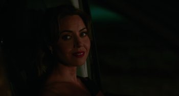 Movie still from “Spin Me Round” (2022), directed by Jeff Baena – A beautiful woman with red lipstick posing for a picture; Close Up shot, Over the shoulder angle