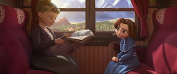 Movie still from “Spirit Untamed” (2021), directed by Ennio Torresan – A boy and a girl sitting on a train looking at each other; Medium shot, High angle