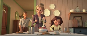 Movie still from “Spirit Untamed” (2021), directed by Ennio Torresan – A woman standing at a table with a vase of strawberries; Medium shot, Over the shoulder angle