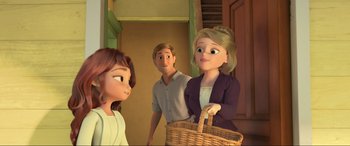 Movie still from “Spirit Untamed” (2021), directed by Ennio Torresan – A woman holding a basket in front of two other people; Medium shot, Over the shoulder angle