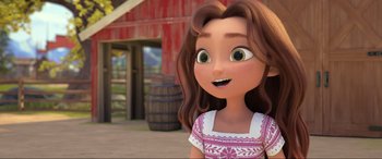 Movie still from “Spirit Untamed” (2021), directed by Ennio Torresan – A cartoon of a young girl with brown hair and a pink and white dress; Close Up shot, Over the shoulder angle