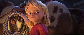 Movie still from “Spirit Untamed” (2021), directed by Ennio Torresan – A girl with blonde hair is looking at the camera; Close Up shot, Over the shoulder angle