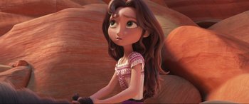 Movie still from “Spirit Untamed” (2021), directed by Ennio Torresan – A woman with long brown hair riding a bicycle; Close Up shot, Over the shoulder angle