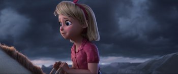 Movie still from “Spirit Untamed” (2021), directed by Ennio Torresan – A young girl with blonde hair and a pink shirt is holding a string; Medium shot, Over the shoulder angle