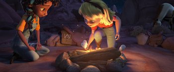 Movie still from “Spirit Untamed” (2021), directed by Ennio Torresan – A cartoon girl lighting a fire in a camp fire; Wide shot, High angle
