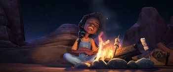 Movie still from “Spirit Untamed” (2021), directed by Ennio Torresan – An animated girl sitting next to a fire; Wide shot, Low angle