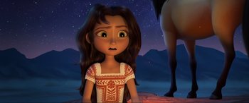 Movie still from “Spirit Untamed” (2021), directed by Ennio Torresan – A young girl with long brown hair is looking at the sky; Medium shot, Over the shoulder angle