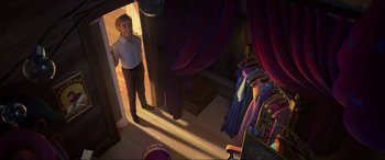 Movie still from “Spirit Untamed” (2021), directed by Ennio Torresan – A man standing next to a room filled with curtains; Wide shot, Over the shoulder angle