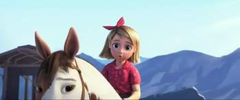 Movie still from “Spirit Untamed” (2021), directed by Ennio Torresan – A girl is standing next to a white horse; Close Up shot, Low angle