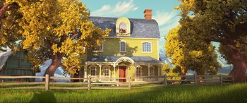 Movie still from “Spirit Untamed” (2021), directed by Ennio Torresan – A yellow house sitting in the middle of a green field; Extreme Wide shot, Low angle