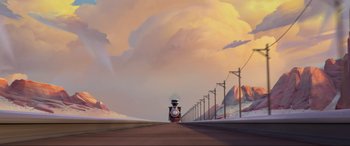 Movie still from “Spirit Untamed” (2021), directed by Ennio Torresan – A train traveling down a road near a mountain; Extreme Wide shot, Low angle