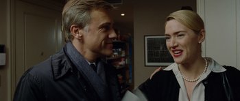 Movie still from “Carnage” (2011), directed by Roman Polanski – A man and a woman are talking to each other; Close Up shot, Over the shoulder angle