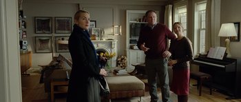 Movie still from “Carnage” (2011), directed by Roman Polanski – A man and a woman standing in a living room; Medium shot, Over the shoulder angle