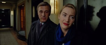 Movie still from “Carnage” (2011), directed by Roman Polanski – A man and a woman standing next to each other; Close Up shot, Low angle