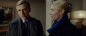 Movie still from “Carnage” (2011), directed by Roman Polanski – A man and a woman standing next to each other; Close Up shot, Over the shoulder angle