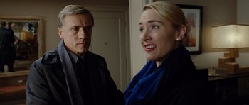 Movie still from “Carnage” (2011), directed by Roman Polanski – A man and a woman standing next to each other in a room; Close Up shot, Over the shoulder angle