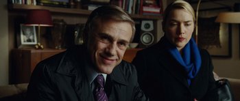 Movie still from “Carnage” (2011), directed by Roman Polanski – A person wearing a suit and tie; Close Up shot, Over the shoulder angle