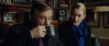 Movie still from “Carnage” (2011), directed by Roman Polanski – A man and a woman are drinking from a mug; Close Up shot, Over the shoulder angle