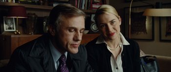 Movie still from “Carnage” (2011), directed by Roman Polanski – A man and a woman sitting next to each other; Close Up shot, Low angle