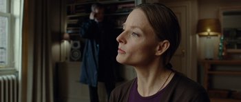 Movie still from “Carnage” (2011), directed by Roman Polanski – A woman looking up into the sky while a man stands in the background; Close Up shot, Over the shoulder angle