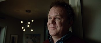 Movie still from “Carnage” (2011), directed by Roman Polanski – A person with curly hair; Close Up shot, Low angle