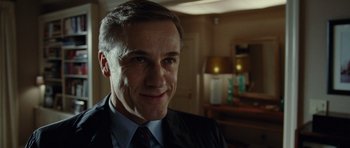 Movie still from “Carnage” (2011), directed by Roman Polanski – A person wearing a suit and tie; Close Up shot, Low angle