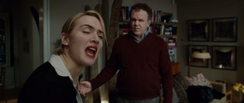 Movie still from “Carnage” (2011), directed by Roman Polanski – A man and a woman in a living room; Close Up shot, Low angle