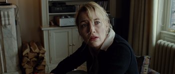 Movie still from “Carnage” (2011), directed by Roman Polanski – A woman sitting in front of a table; Close Up shot, Low angle
