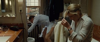 Movie still from “Carnage” (2011), directed by Roman Polanski – A man and a woman in a bathroom; Medium shot, Over the shoulder angle