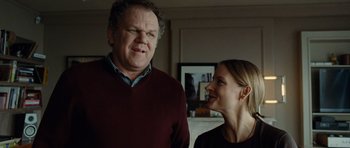 Movie still from “Carnage” (2011), directed by Roman Polanski – A man and a woman standing next to each other in a room; Medium shot, Low angle