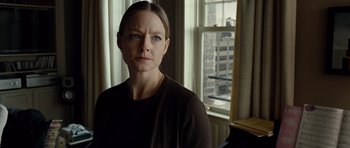 Movie still from “Carnage” (2011), directed by Roman Polanski – A woman standing in front of a window in a room; Close Up shot, Low angle