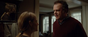 Movie still from “Carnage” (2011), directed by Roman Polanski – A man and a woman looking at each other in a room; Medium shot, Over the shoulder angle