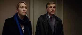 Movie still from “Carnage” (2011), directed by Roman Polanski – A man and a woman standing next to each other; Close Up shot, Low angle