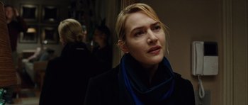 Movie still from “Carnage” (2011), directed by Roman Polanski – A person wearing a jacket and a scarf; Close Up shot, Over the shoulder angle
