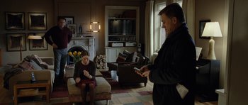 Movie still from “Carnage” (2011), directed by Roman Polanski – A man and a woman are in a living room; Wide shot, Low angle