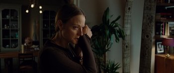 Movie still from “Carnage” (2011), directed by Roman Polanski – A woman in a brown shirt is looking at the camera; Close Up shot, Low angle